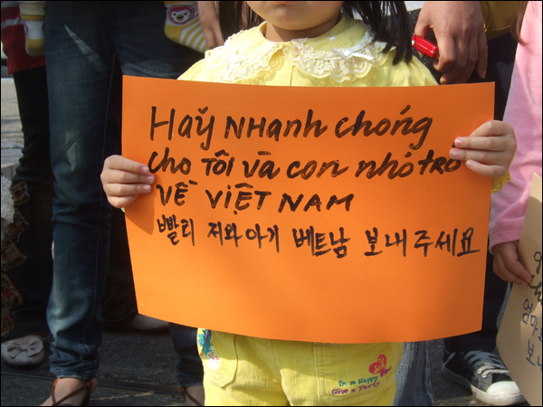 한 베트남 어린이가 "빨리 저와 아기 베트남으로 보내주세요"라는 문구가 적힌 피켓을 들고 있다 / 사진. 평화뉴스 박광일 기자