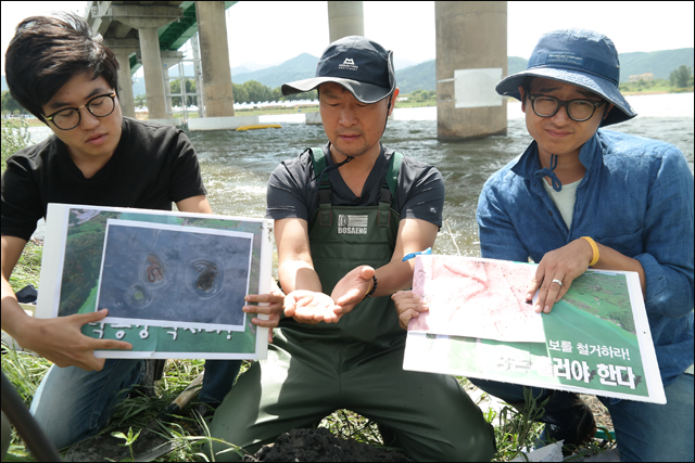 환경단체 활동가들이 낙동강에서 발견된 실지렁이와 사진을 보이고 있다(2016.8.31. 경북 고령군 사문진교) / 사진.평화뉴스 김지연 기자