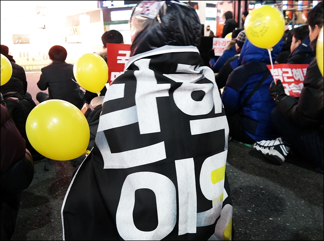 헌재의 탄핵 인용 현수막을 두른 시민(2017.1.14) / 사진.평화뉴스 김지연 기자