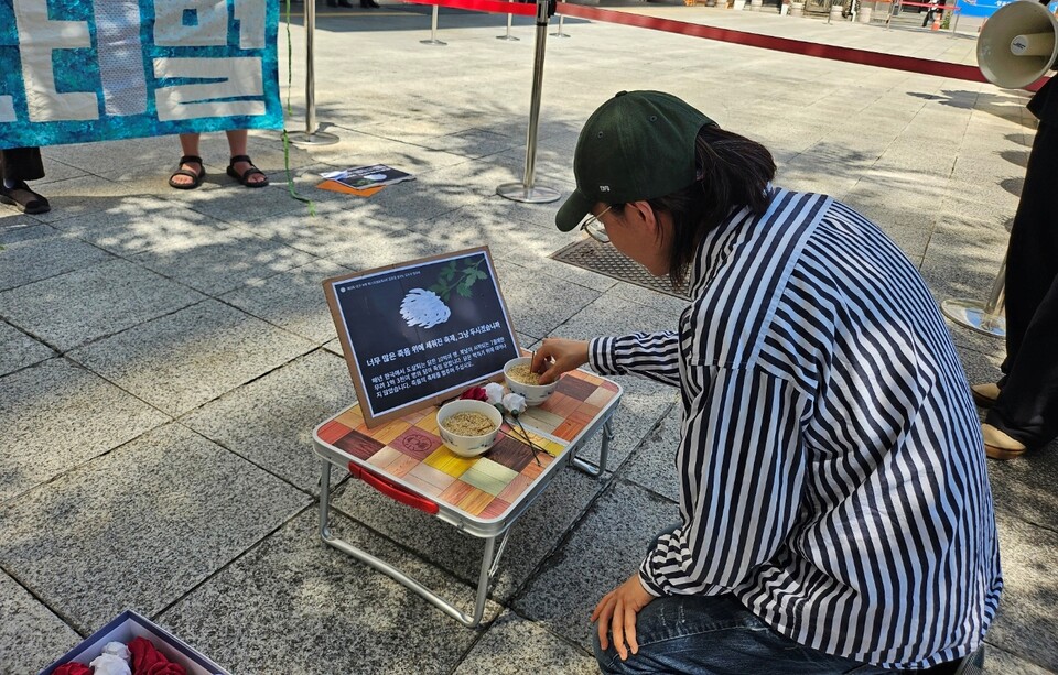이재효 '대구동물권행동 비긴' 활동가가 치맥축제로 희생된 닭들을 추모하기 위해 향을 붙이고 있다.(2024.7.3) / 사진.평화뉴스 정준민 기자
