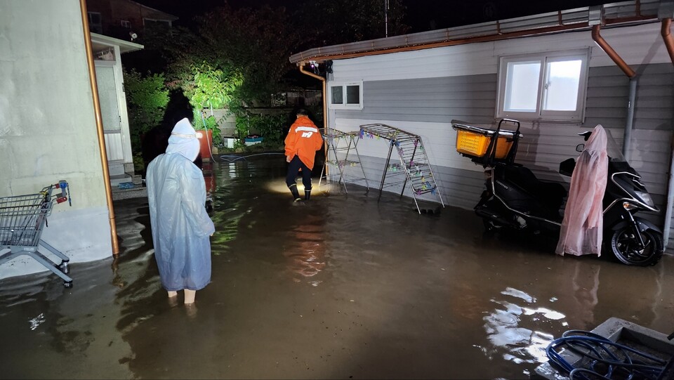 대구 달성군 가창면 녹문길 한 집안에 한밤 중 물이 들이찼다는 신고가 들어와 소방대원들이 펌프로 물을 퍼내는 작업을 하고 있다.(2024.7.9) / 사진.대구소방본부
